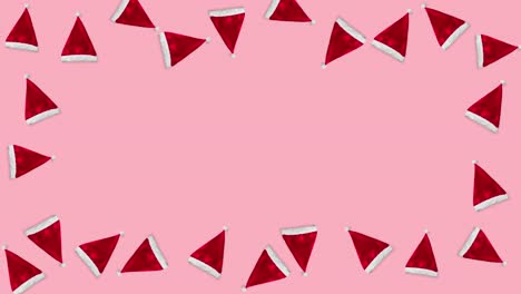 muchos sombreros rojos de santa claus flotando en un fondo rosa de navidad como un marco. animación de bucle sin costuras de un patrón con espacio de copia. concepto de vacaciones