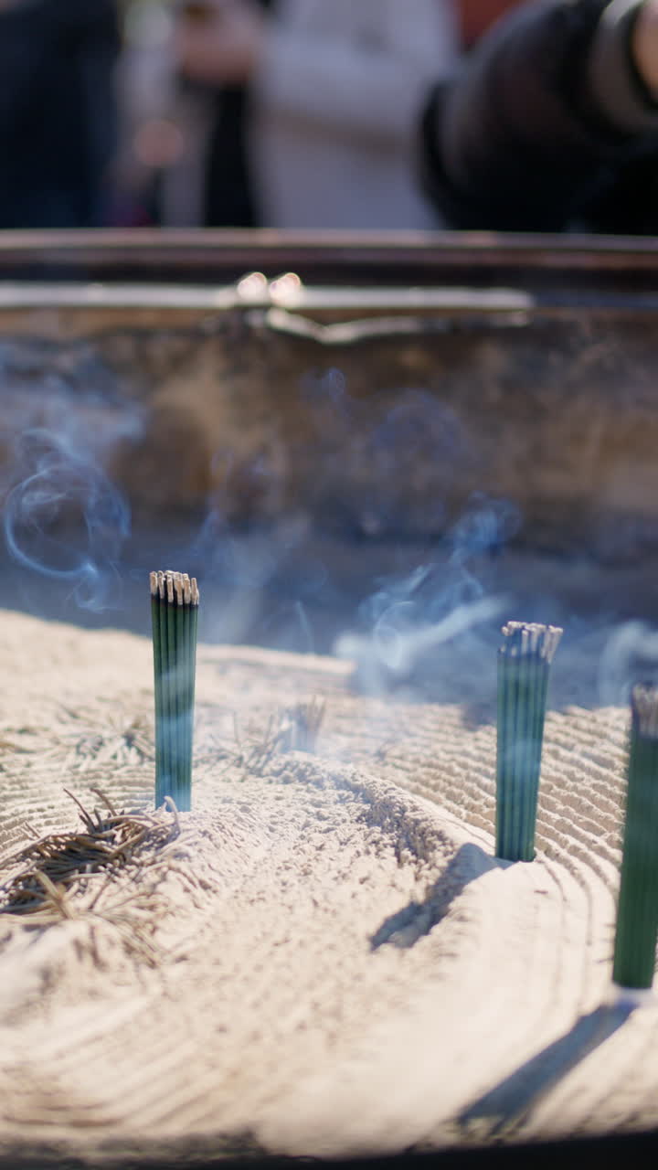 Incense burning on a jokoro at the Senso-ji temple in daylight in Asakusa, Japan. Vertical