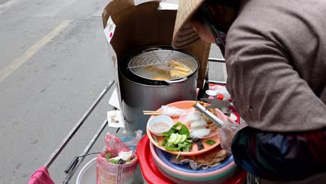 vendor assembling a dish with fresh ingredients