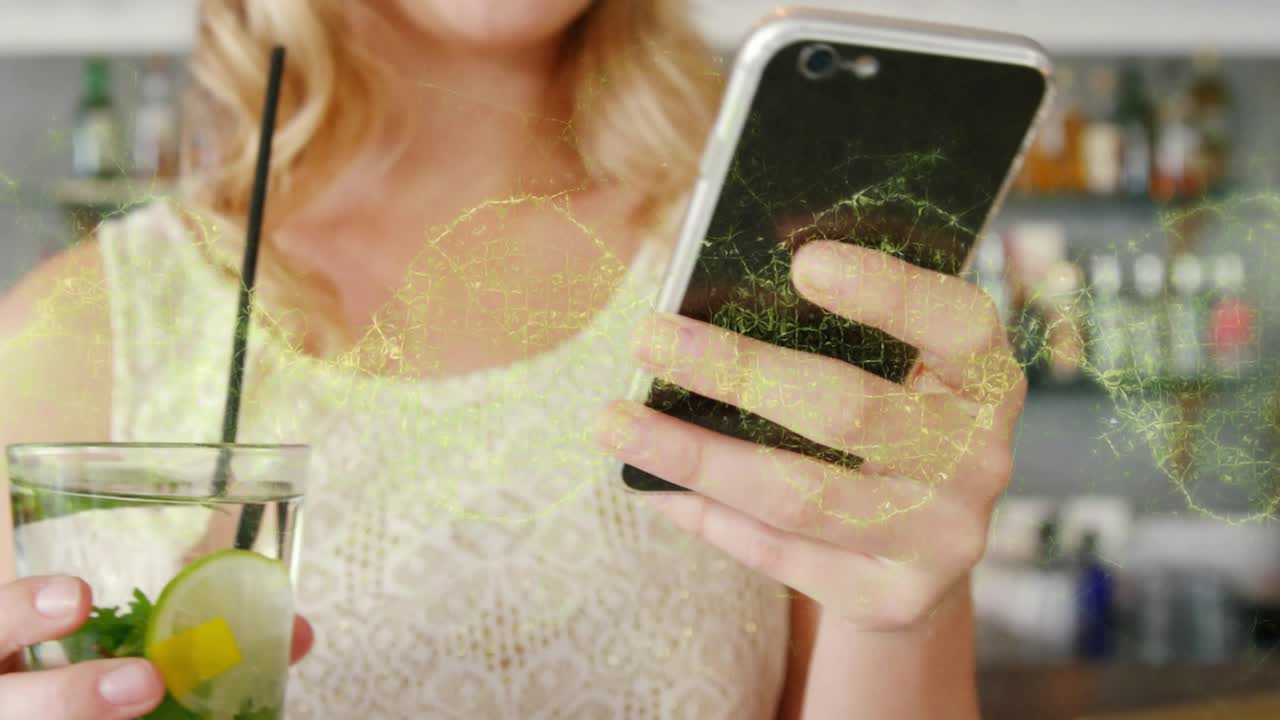 Woman holding smartphone at bar initiating technology network and connecting cocktail via data wave