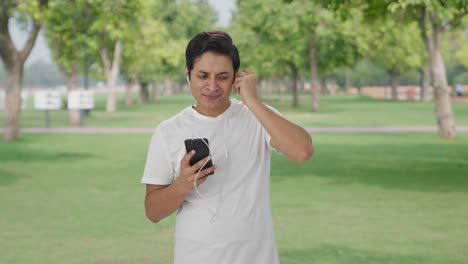 Happy-Indian-man-listening-songs-on-earphone-and-dancing