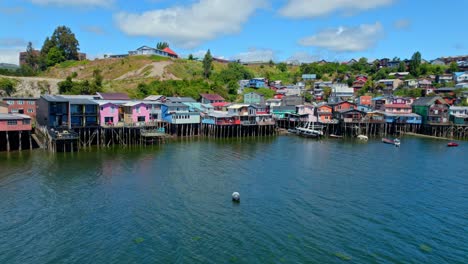 aerial panoramic sea landscape of stilt houses in castro chiloé chile patagonian sea island natural travel destination, colorful homes above water, drone establishing shot, south america