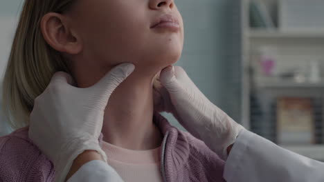 doctor examining patient's thyroid