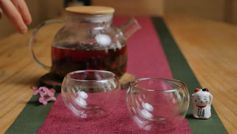 pouring tea into glass teacups