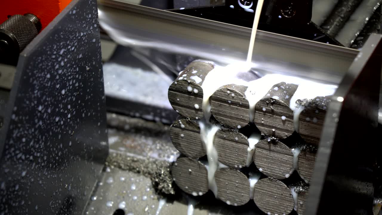 The band saw machine cutting the raw material rods .