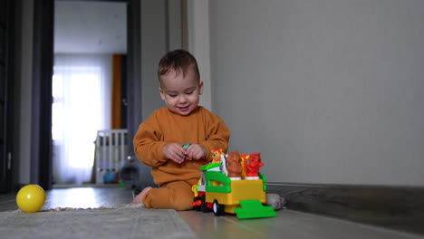 baby playing with toy truck
