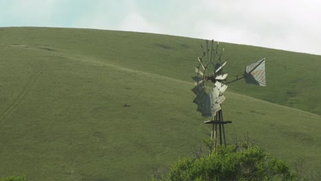 windmill in front of pastoral california hills close up 4k