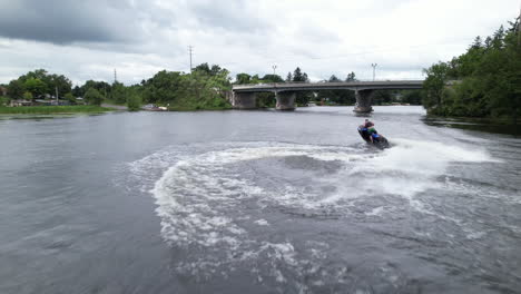 blue jetski carving the waves aerial