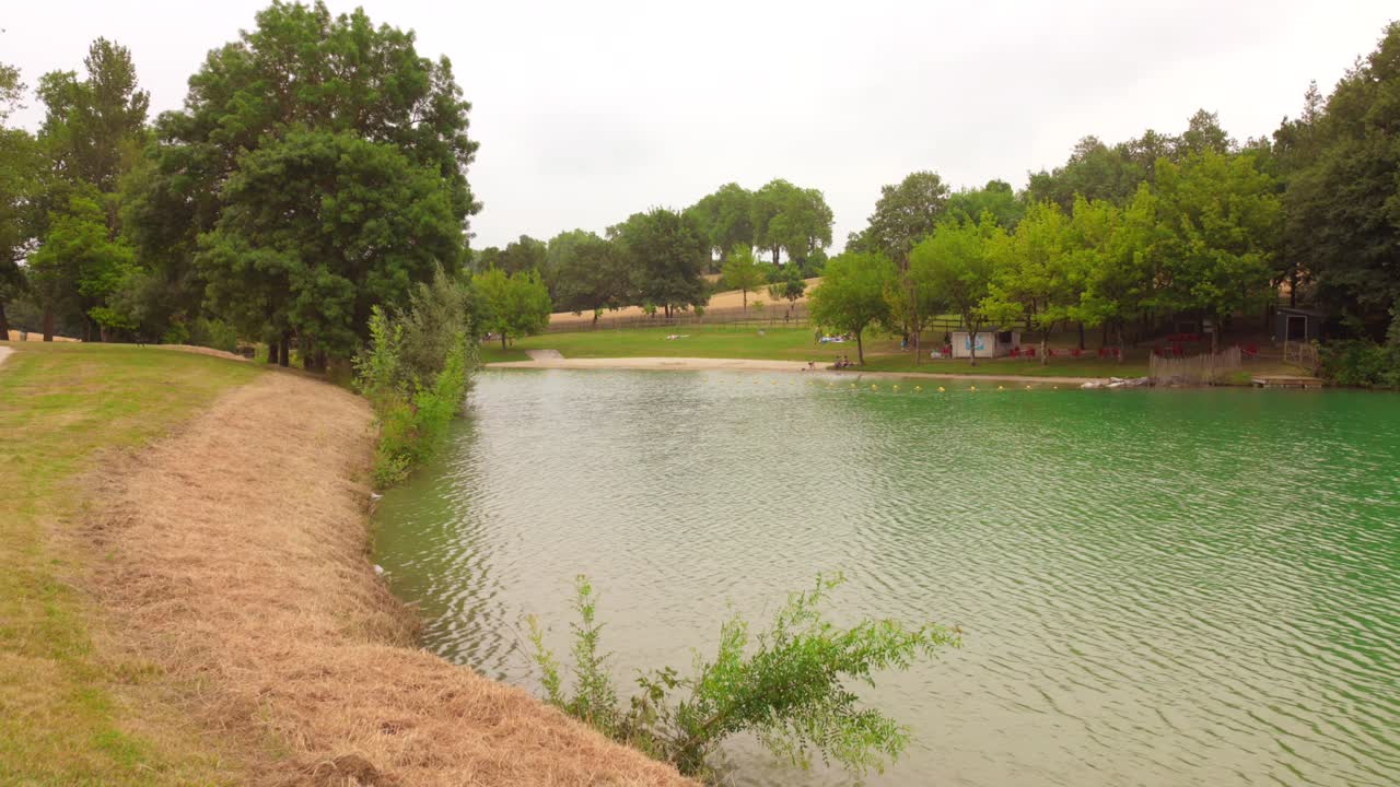 Profile view of "Lac de L'Orme Blanc" (a lake) in Caraman, France near Toulouse. The beautiful turquoise water colored