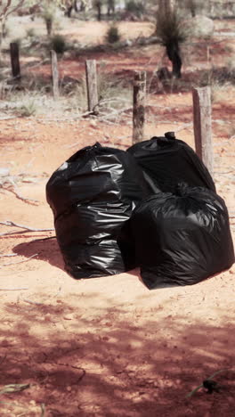 black garbage bags in a desert landscape