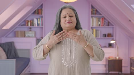 indian old woman doing breathe in breathe out exercise