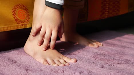 child examining their ankle