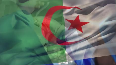 animation of waving algeria flag over female surgeon tying surgical mask on male surgeon at hospital