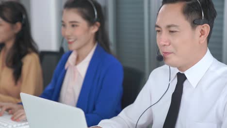 business people wearing headset working actively in office