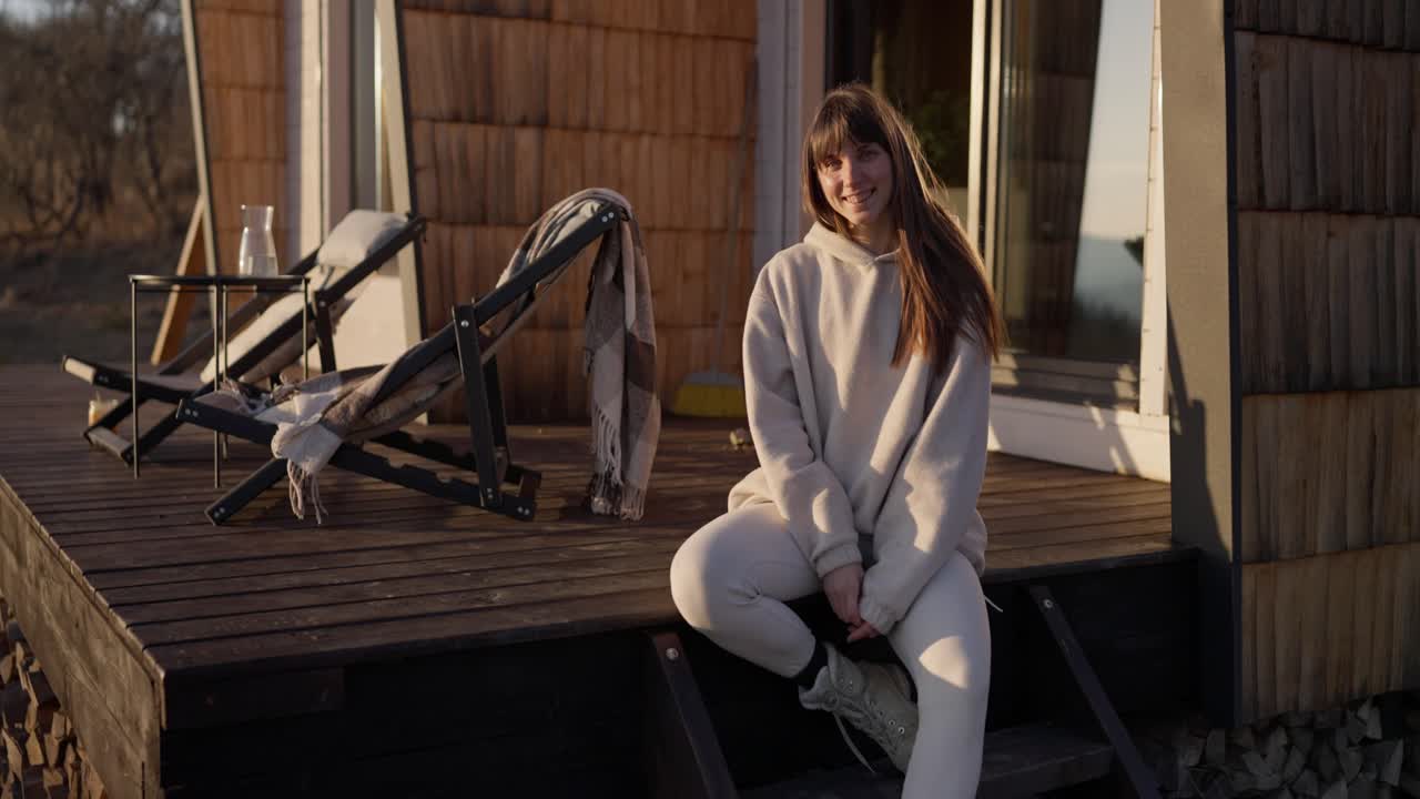 Woman Sitting on Porch Deck