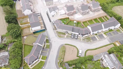 Aerial-view-of-a-new-housing-development,-half-built,-in-a-rural-area-of-Devon,-UK