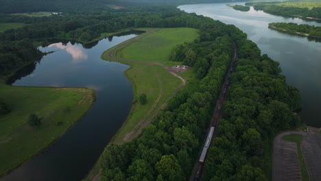 train passes through spadra park, near clarksville and arkansas river - day aerial wide shot