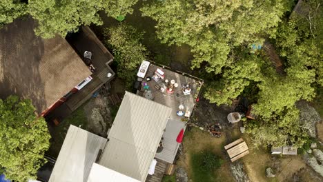 Top-down-aerial-descend-over-top-of-musicians-playing-their-instruments-for-a-dancing-audience-off-stage