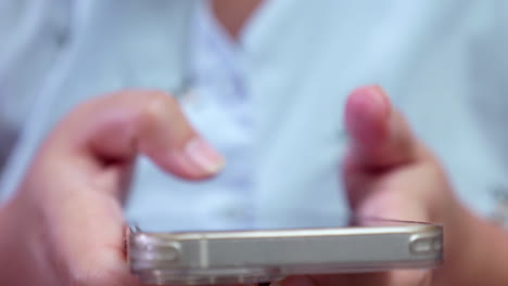 Close-up-of-an-individual-browsing-the-internet-and-updating-social-media-using-a-mobile-phone