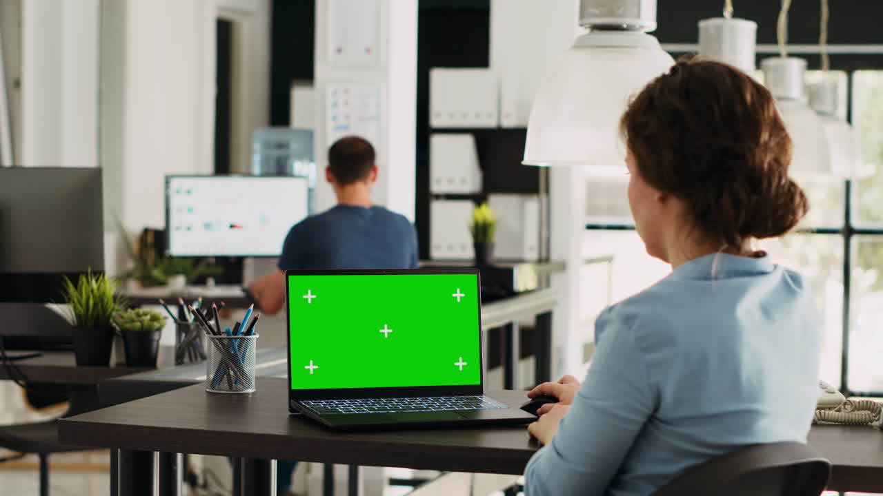 Premium stock video - Startup worker checks greenscreen on pc