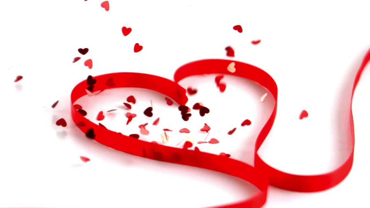 많은 콘페티가 심장 리본에 떨어집니다.