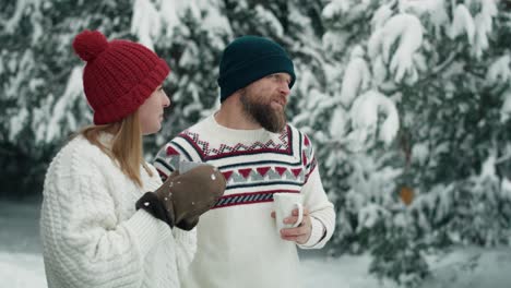 caucasian couple drinking hot tea and talking together in winter time.