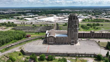 An-aerial-view-of-the-green-city-of-Buffalo,-New-York-of-a-beautiful-summer-day-with-the-Grand-Central-Station-and-railroad-yard-in-the-background