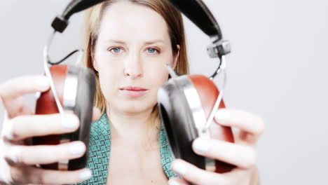 cool female dancer with changing retro headphones to listen to music