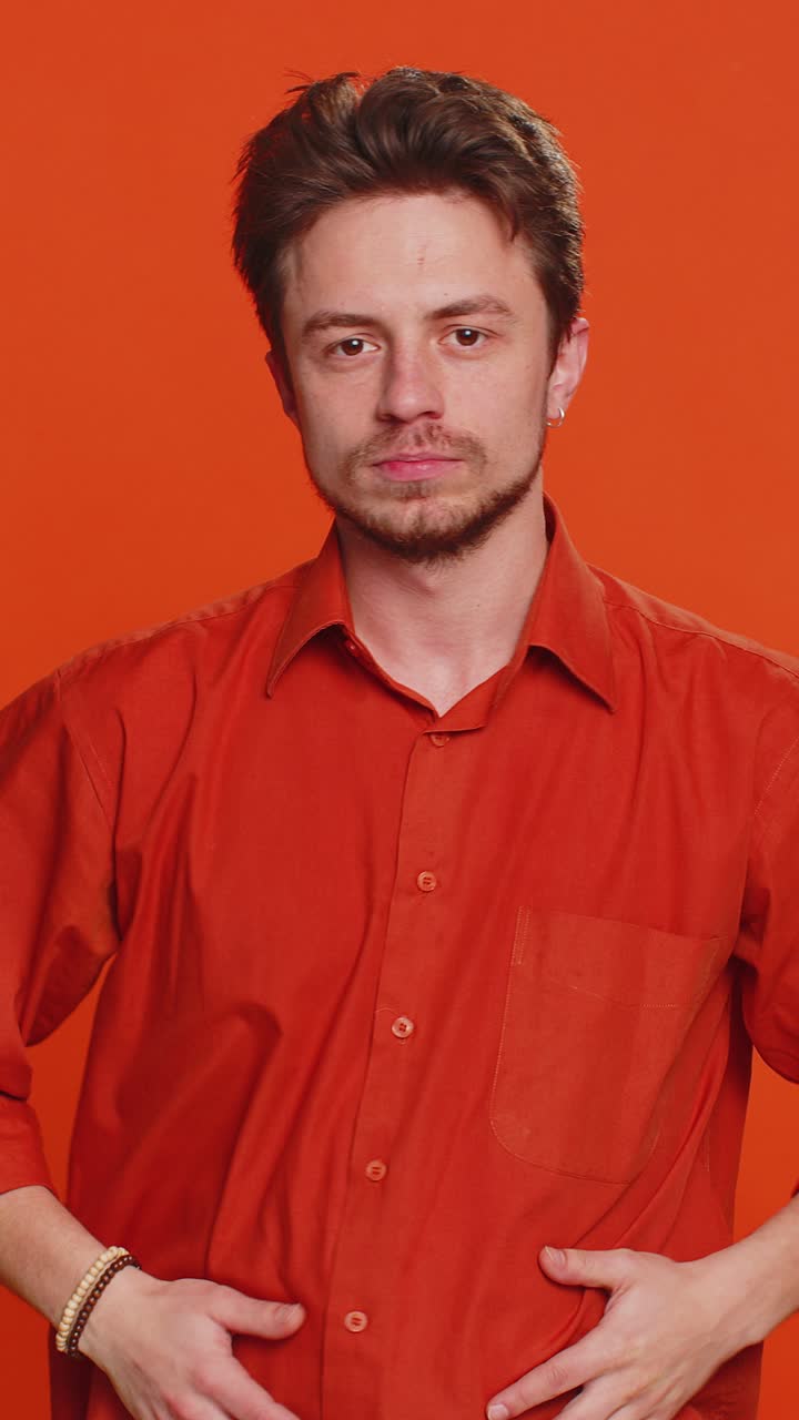 Young man says no hold palm folded crossed hands in stop gesture warning of finish prohibited access