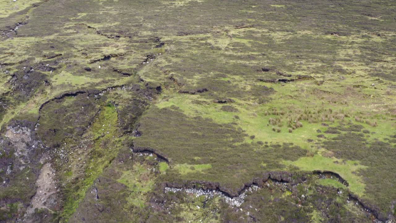 Layers of rock and sediment along exposed eroded hillslope mountain, achill island ireland