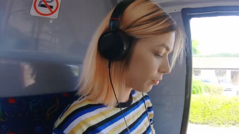 girl listening music on a bus 4k