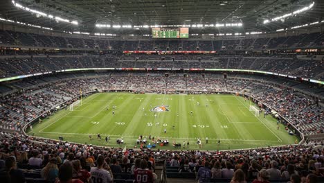 aerial view of an expansive stadium filled with enthusiastic fans and players engaged in an exciting match in a packed arena