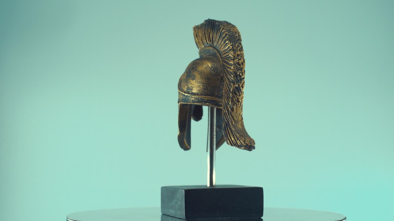 un primer plano giratorio de un casco de bronce de metal griego antiguo guerrero espartano, con formas y formas, iluminación de estudio, cámara lenta, video de 4k