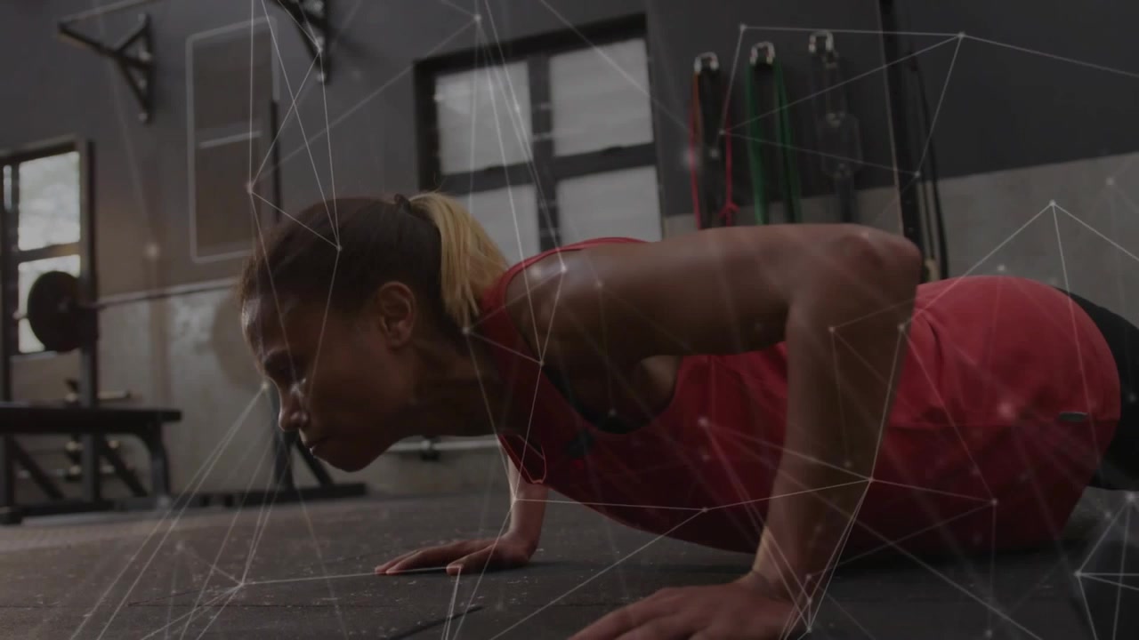 Mid adult woman starting plank and doing pushups on mat, network overlay showing muscle for fitness