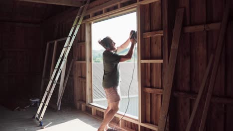 grinding wood on window, wood dust on clothes, building a barn