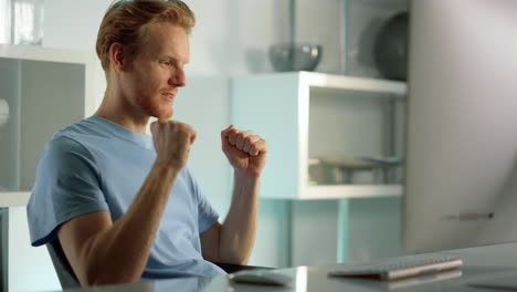 worker talking online celebrating success results at remote office close up.