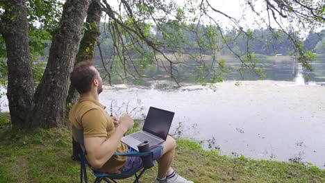 happy and joyful man working with laptop.