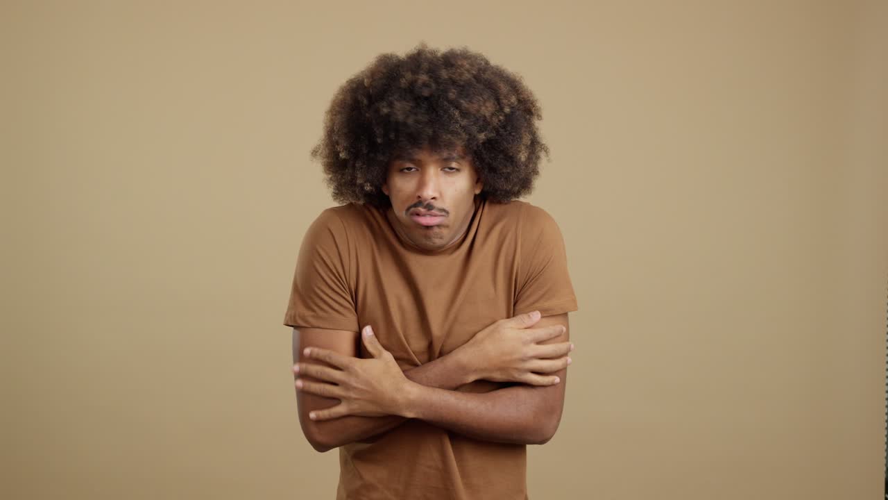 Man shivering from cold in a studio