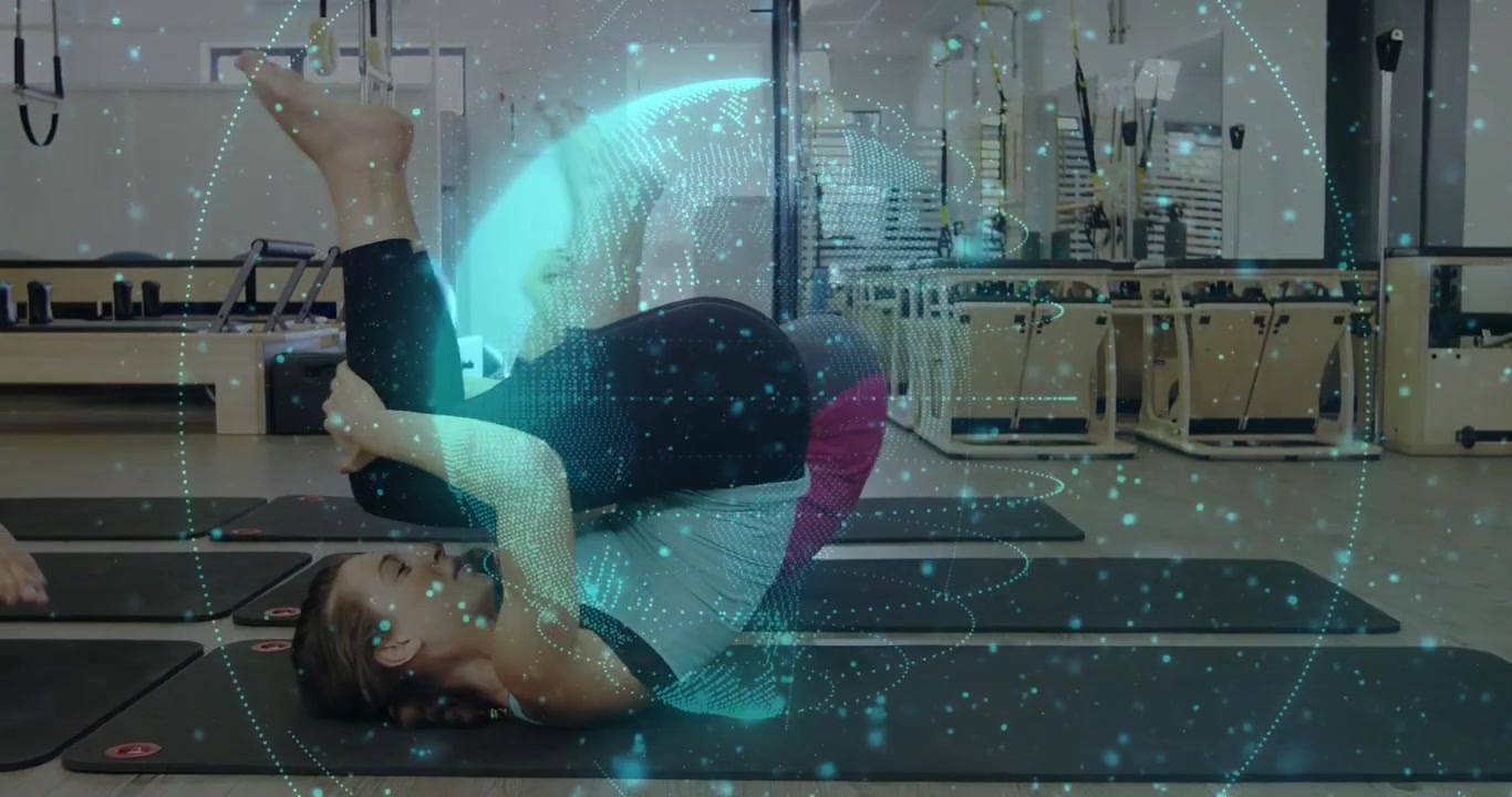 Cyan globe appearing and pulsing, initiating two women rolling and curling, guiding core workout