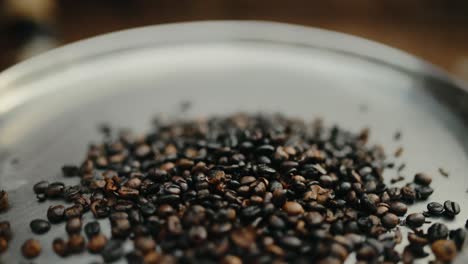 robusta coffee beans being roasted on metal plate in uganda