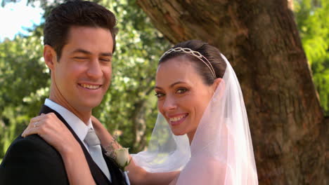 newlyweds standing in the park