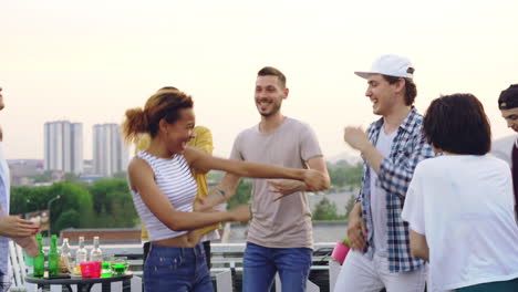 friends dancing on rooftop party