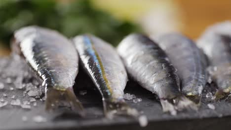 fresh sardines on a cutting board