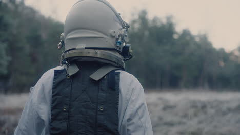 astronaut in space suit walking trough forest clearing