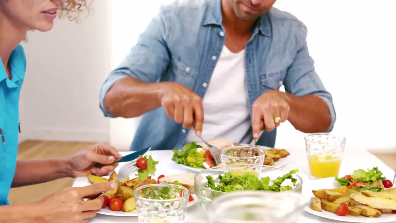 Cute family having lunch on the table