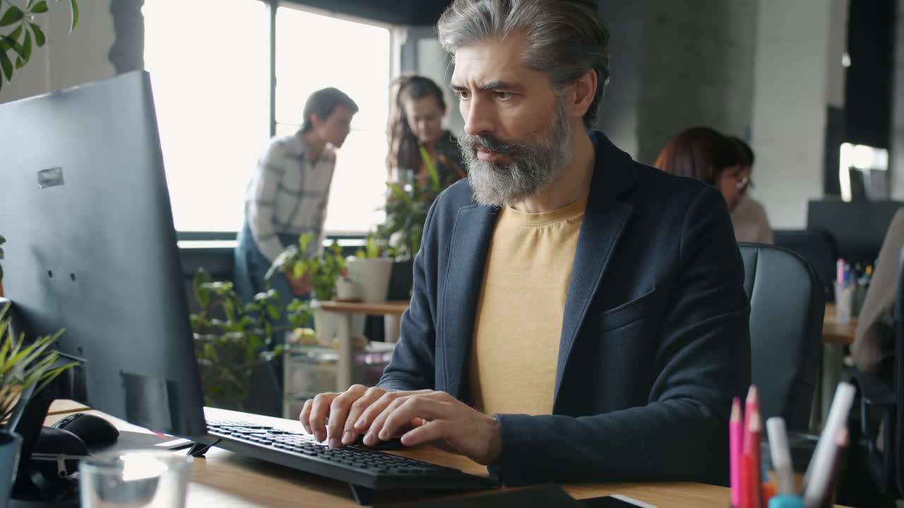 Stressed Businessman with Headache at His Desk
