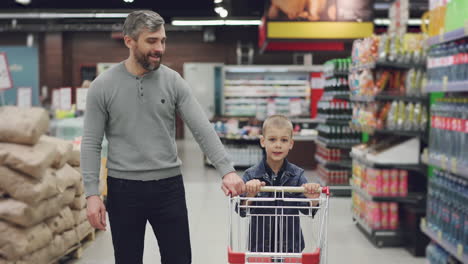 father and son shopping at a supermarket