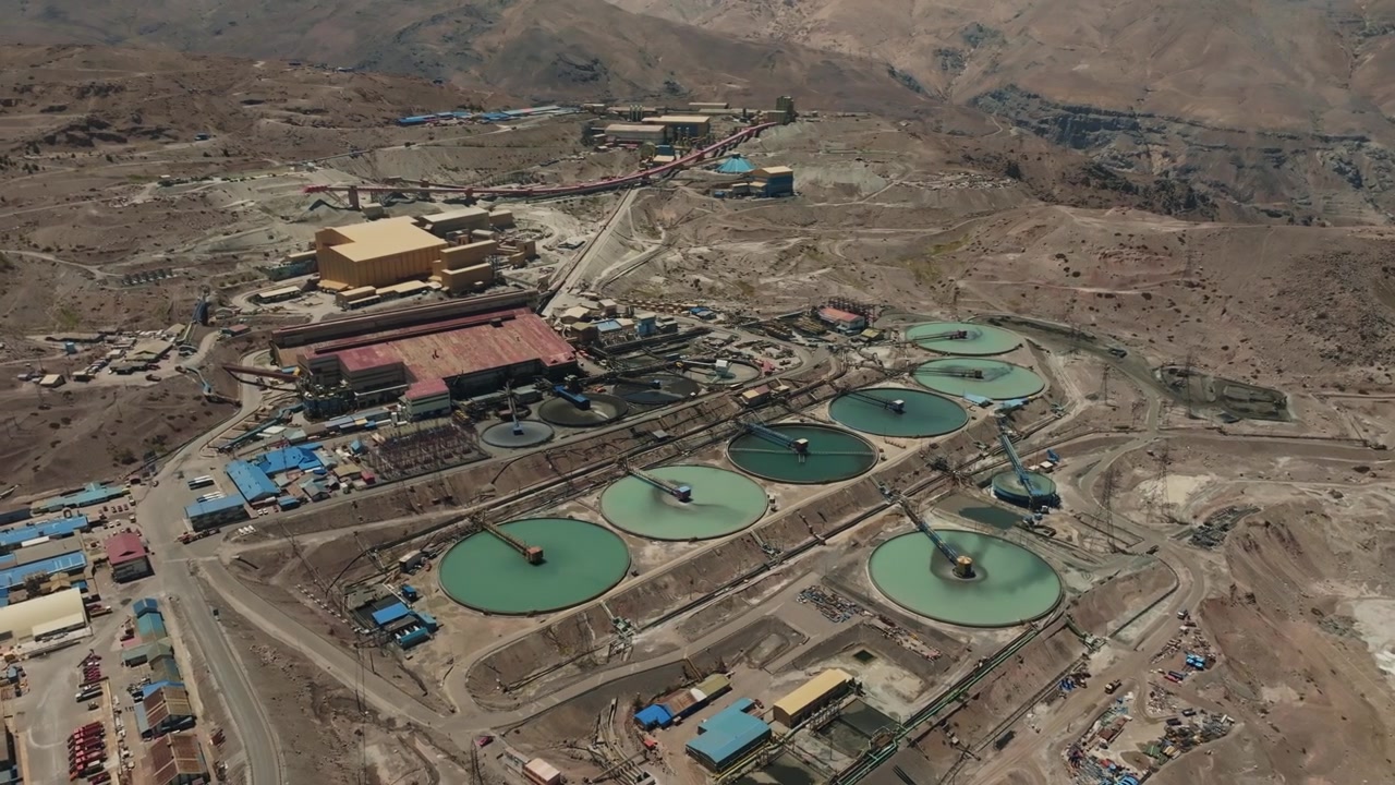 Professional drone orbit around large circular tailings management infrastructure in Chile. The footage captures environmental technology, mineral processing operations, and industrial-scale water rec