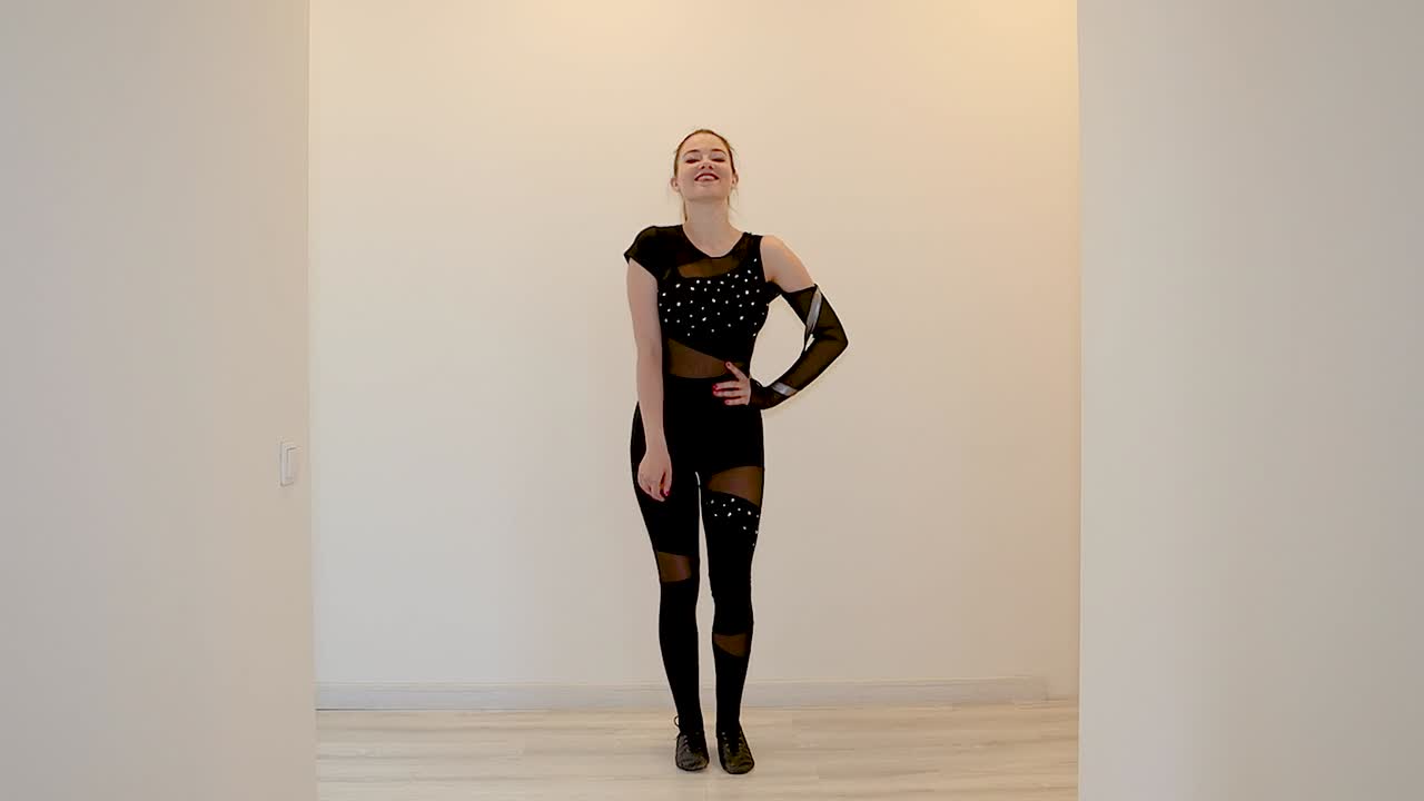 Female dancer practicing a dance routine at home wearing a black outfit in slow motion