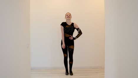 female dancer practicing a dance routine at home wearing a black outfit in slow motion